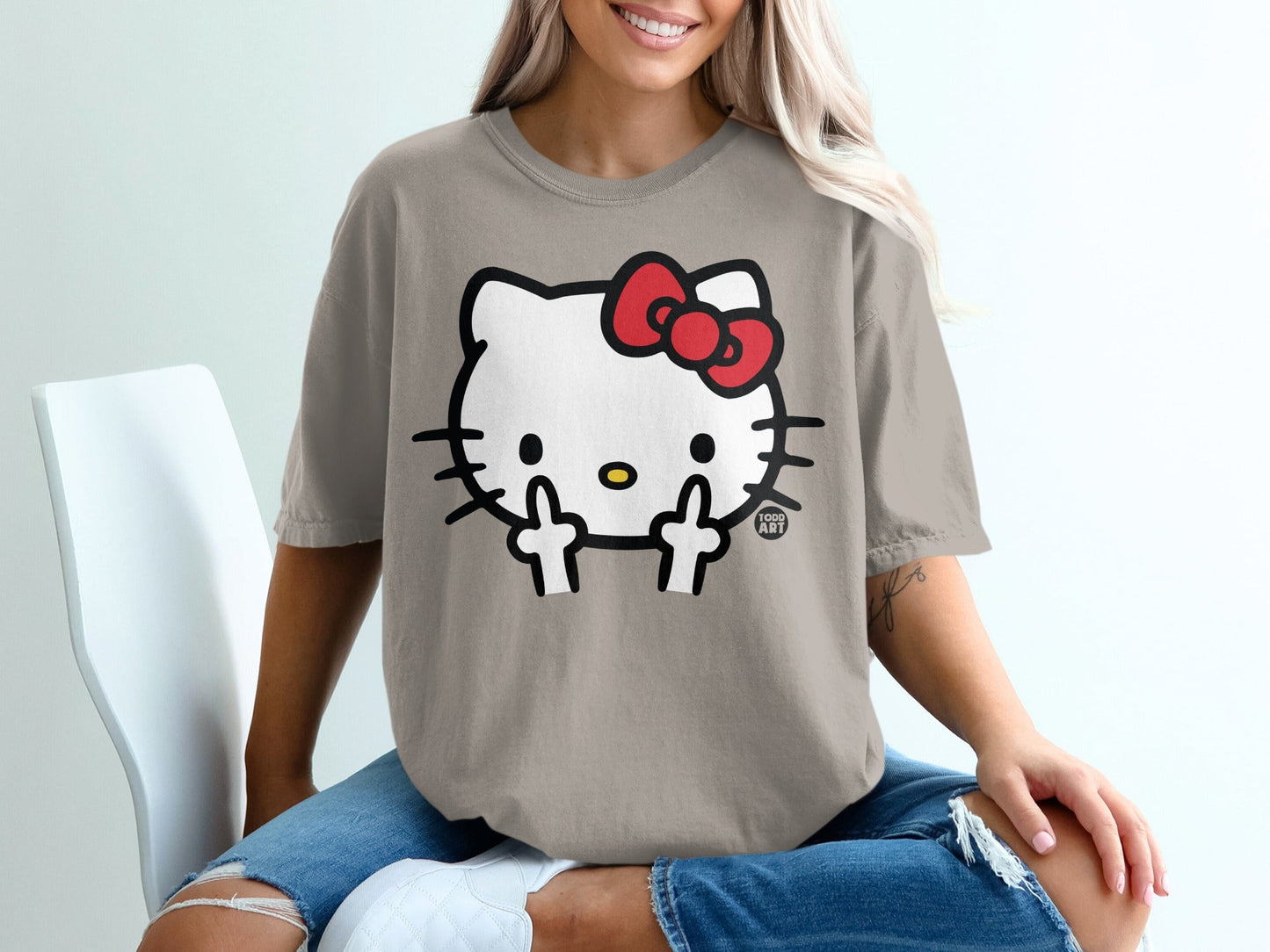 Hello Kitty graphic t-shirt with a red bow and middle fingers.