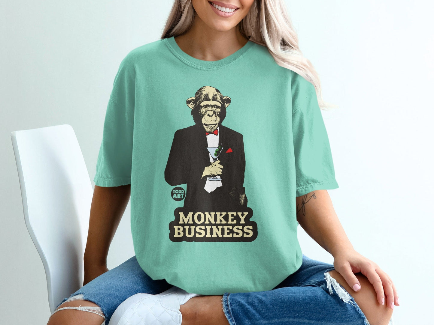 Mint t-shirt with a monkey in a tuxedo holding a martini, text reads "Monkey Business".