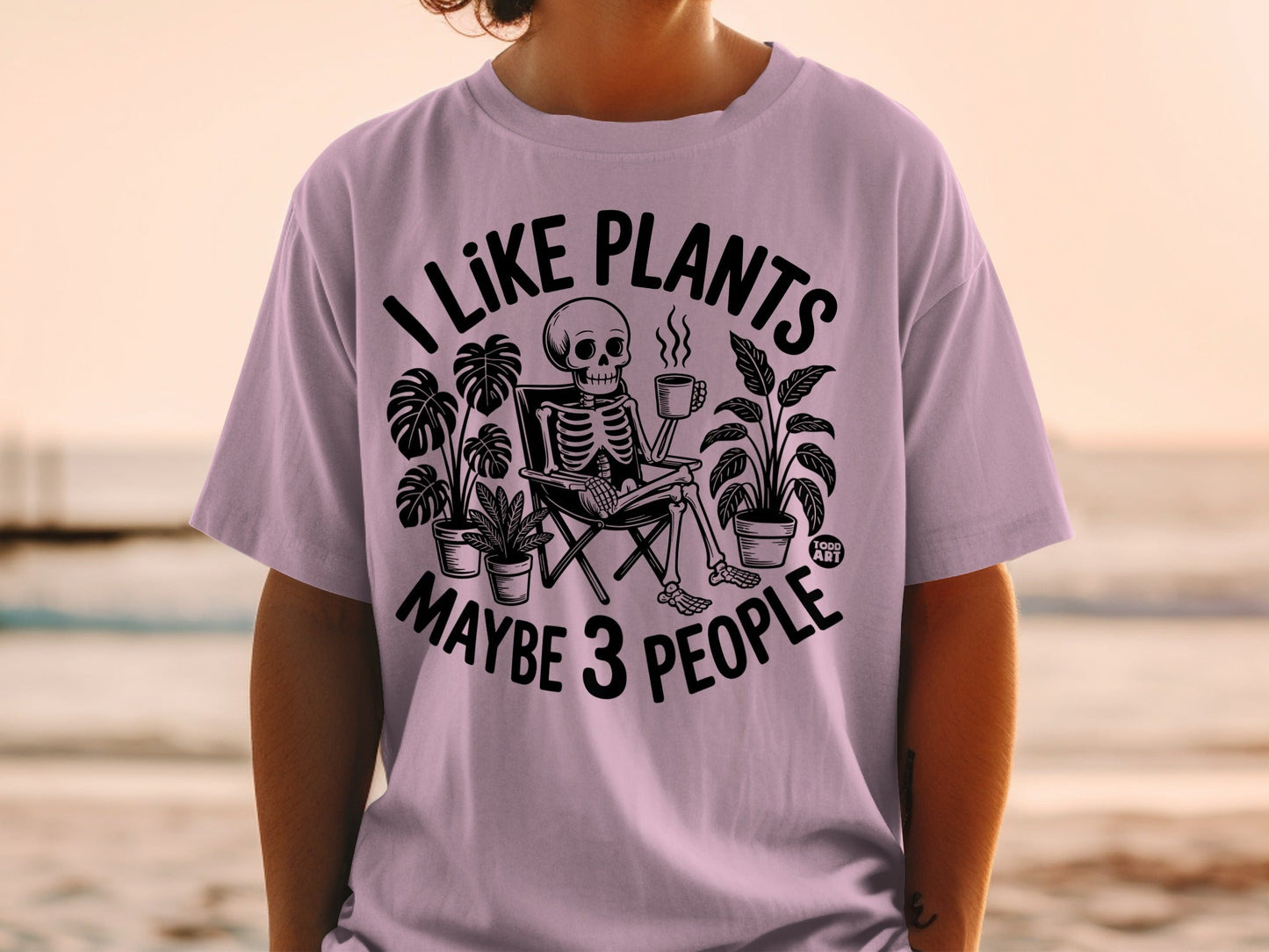 Skeleton in chair with plants and mug, text "I LIKE PLANTS MAYBE 3 PEOPLE".