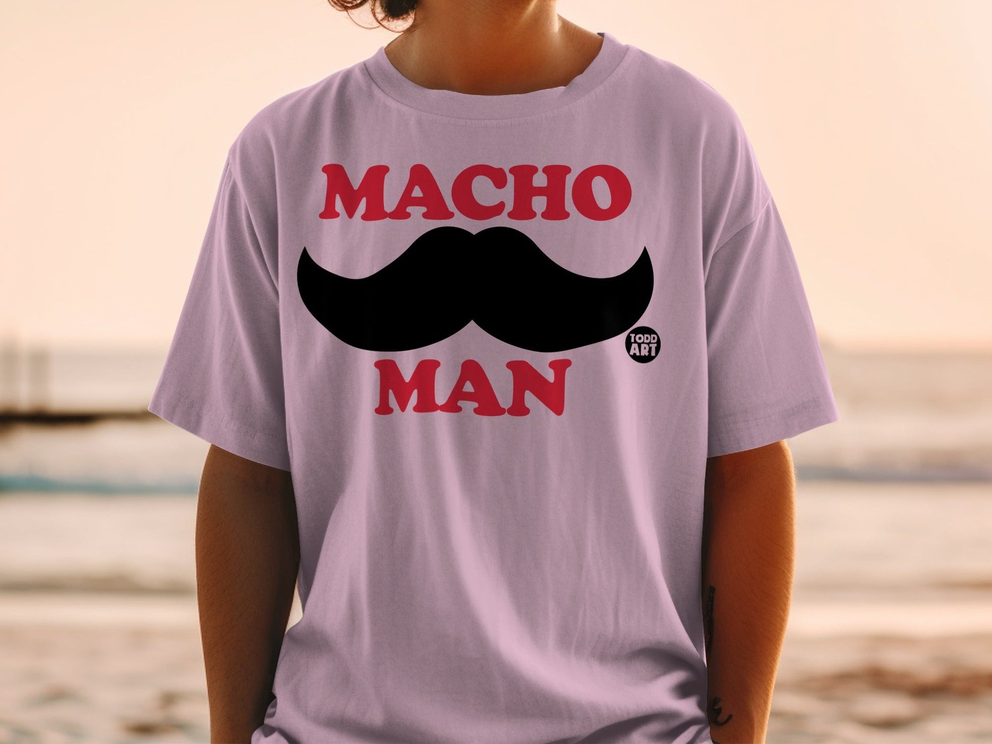 Purple t-shirt with black mustache and "MACHO MAN" text.