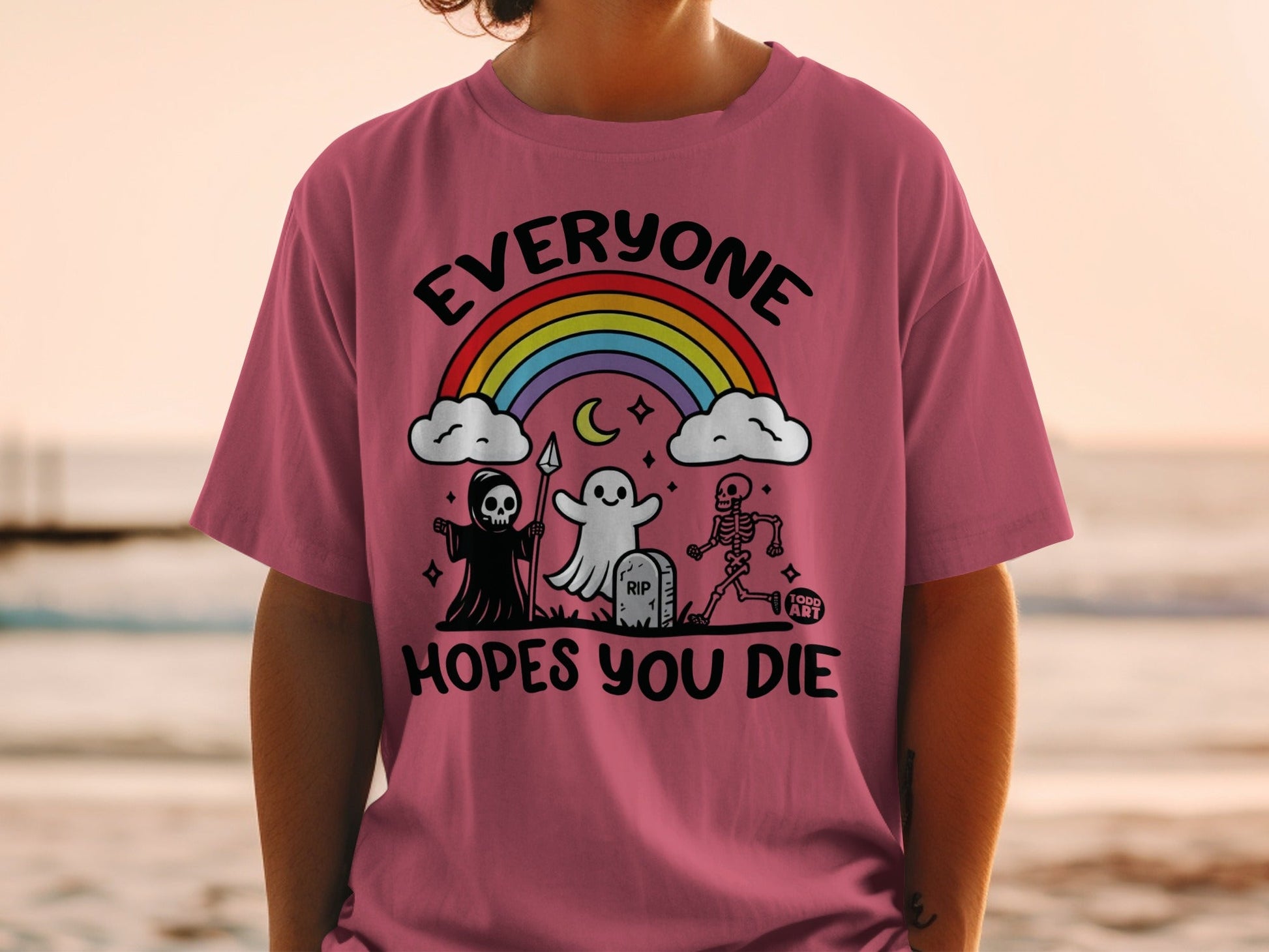 Pink t-shirt with Halloween characters and rainbow, "Everyone Hopes You Die" text.