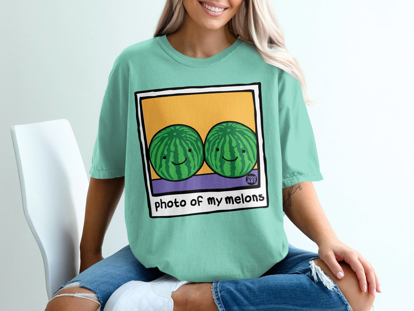 Two smiling cartoon watermelons inside a framed polaroid with text "photo of my melons".