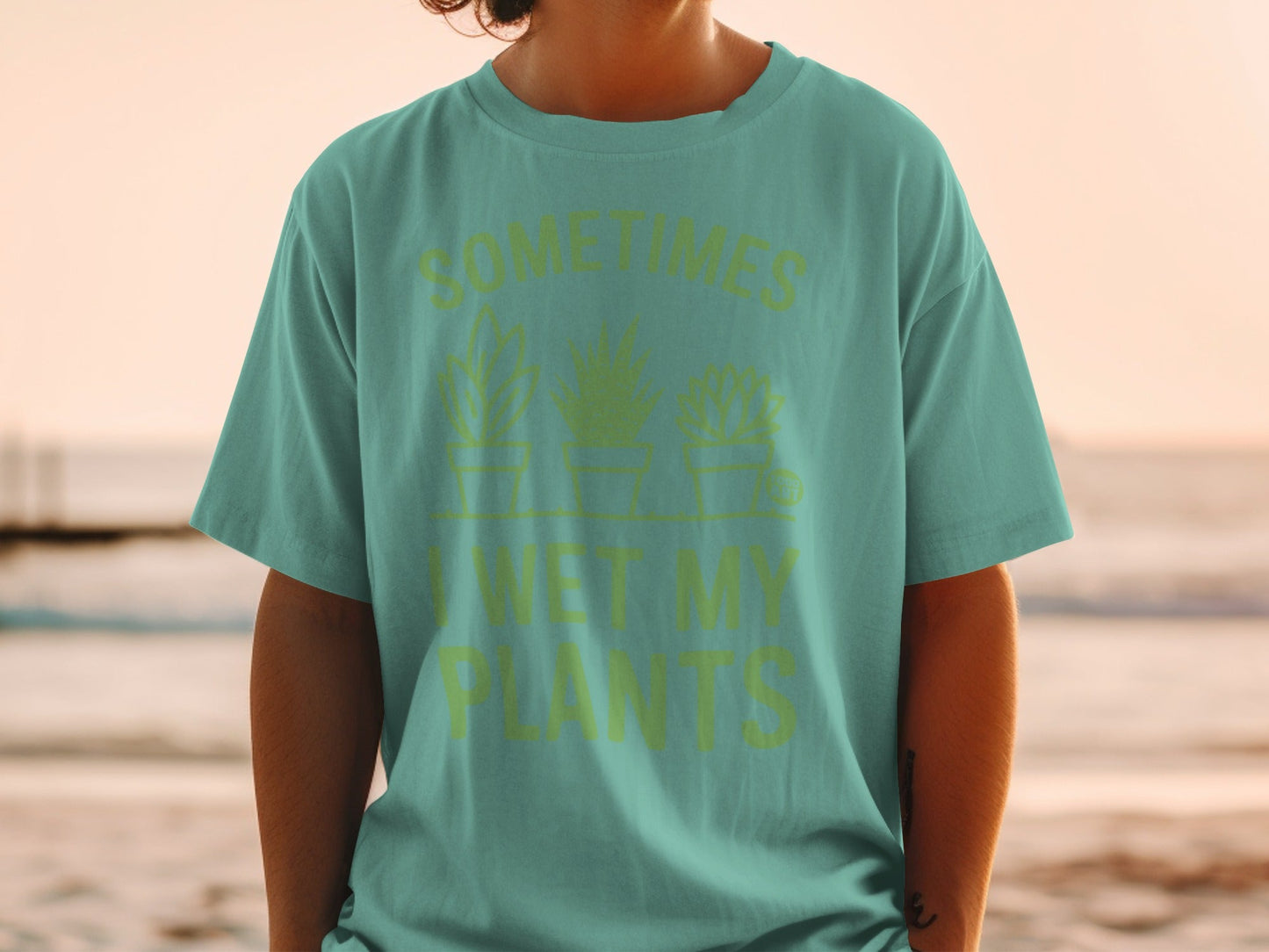 Teal t-shirt with "SOMETIMES I WET MY PLANTS" text and potted plants.