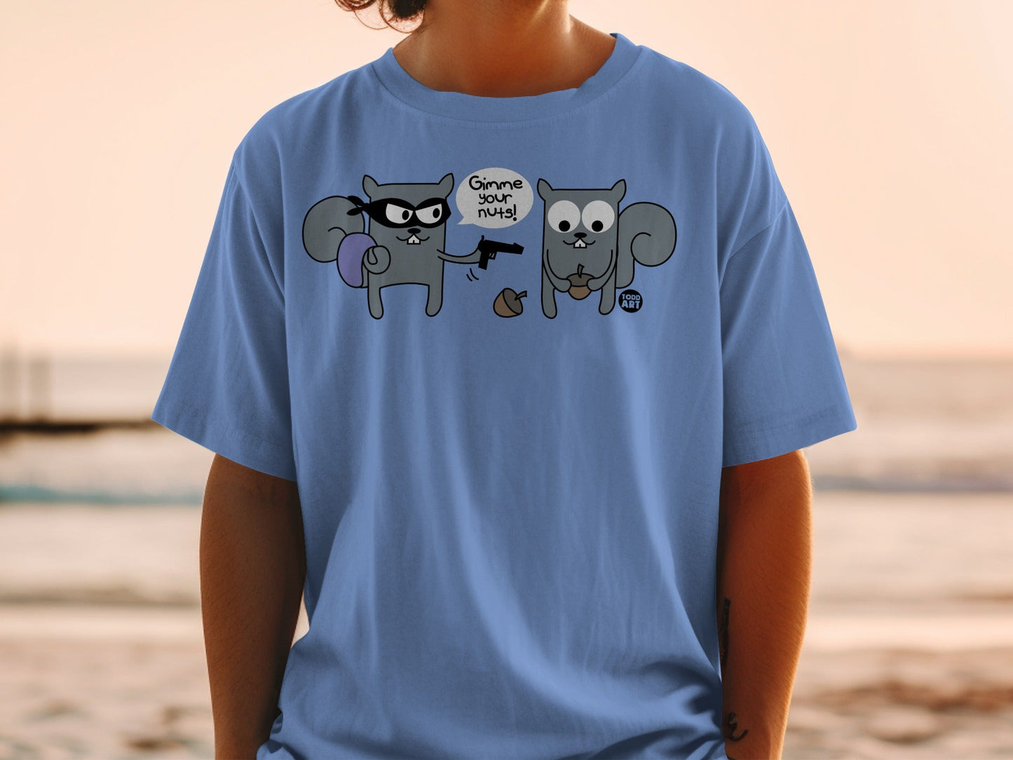 T-shirt with illustration of two squirrels, one with a mask and gun demanding nuts.