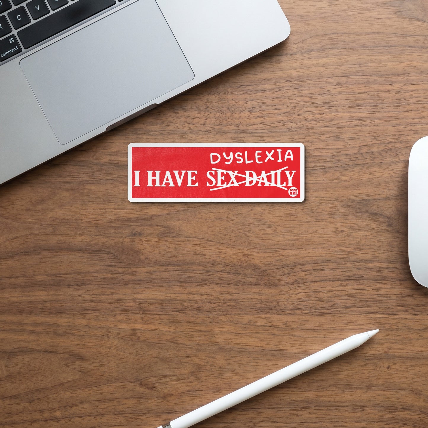Red sticker with white text "I HAVE DYSLEXIA SEX DAILY" with "SEX DAILY" crossed out.