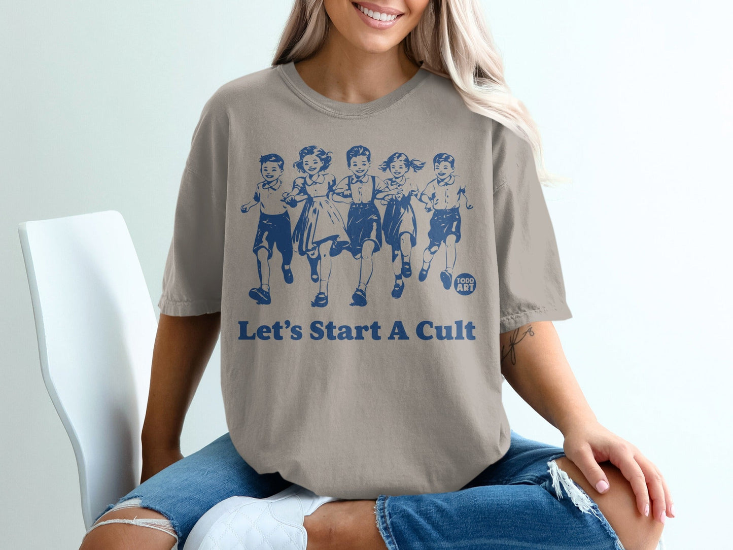 T-shirt with children running and text "Let's Start A Cult"