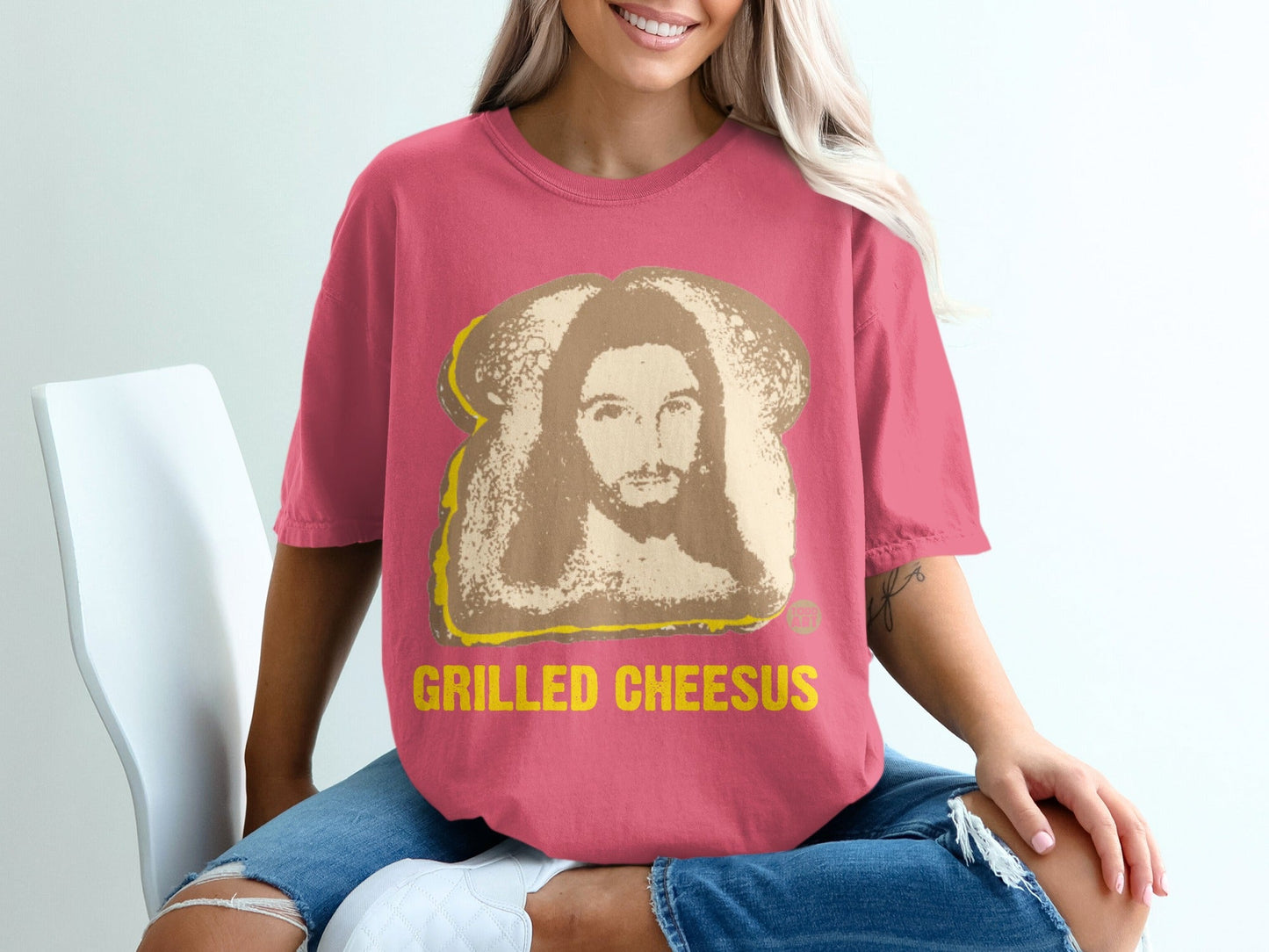 Pink t-shirt featuring Jesus' face on a grilled cheese sandwich design.