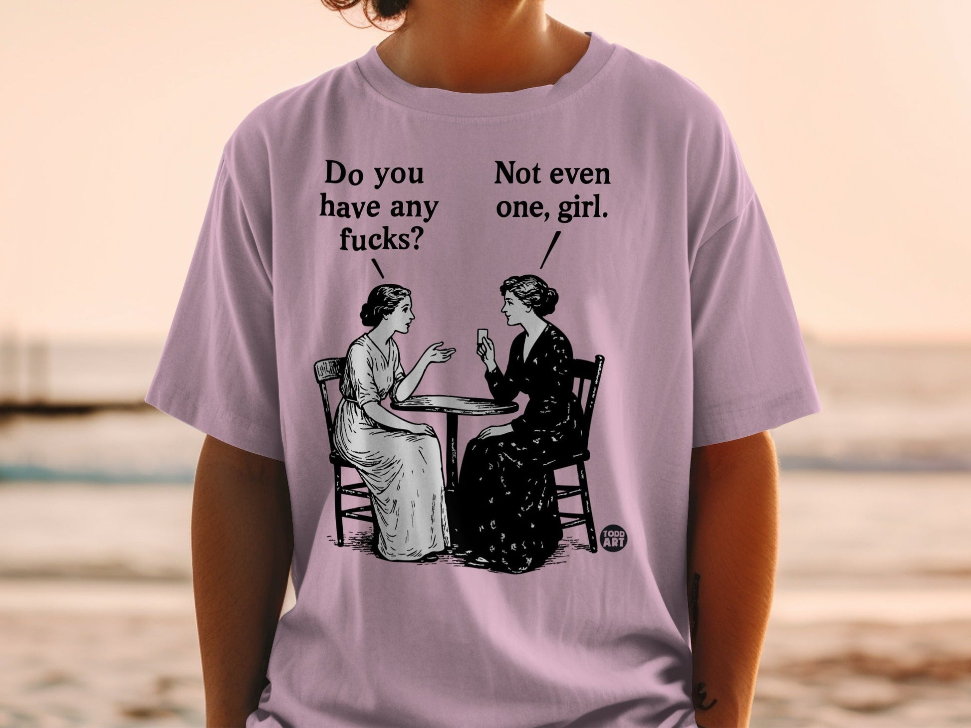 Two women sitting at a table, one asking "Do you have any fucks?".