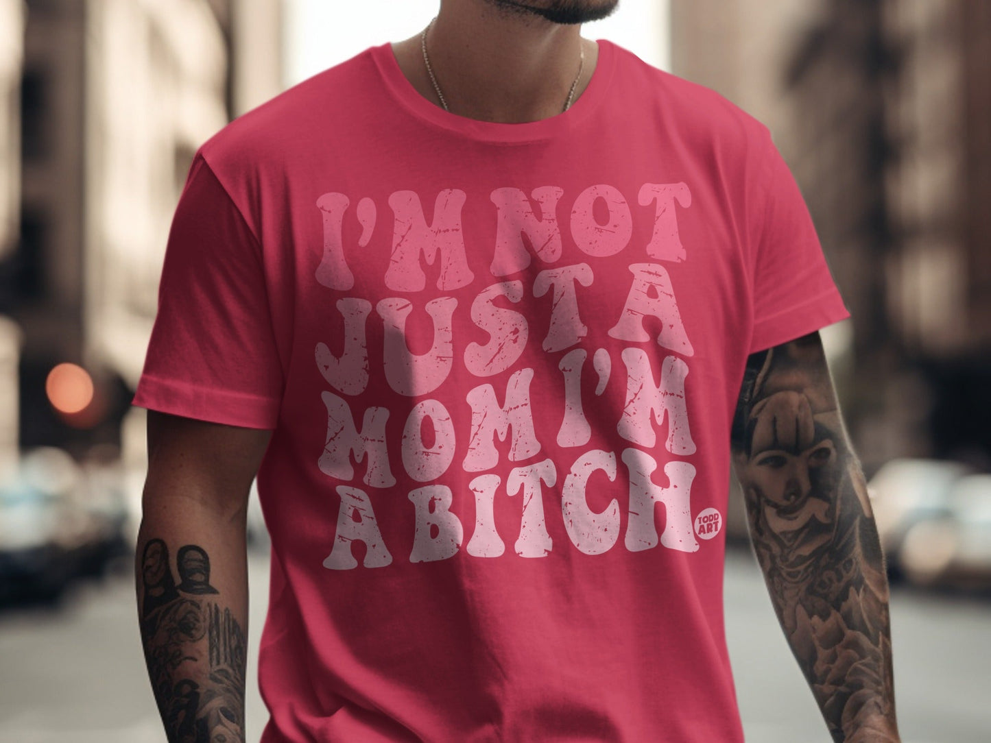 Pink t-shirt with white text "I'M NOT JUST A MOM I'M A BITCH".