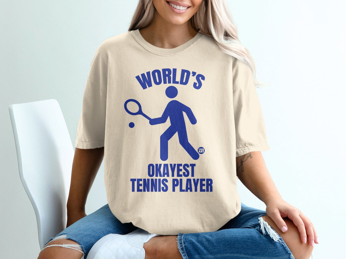 "World's Okayest Tennis Player" text on a blue graphic of a person playing tennis.