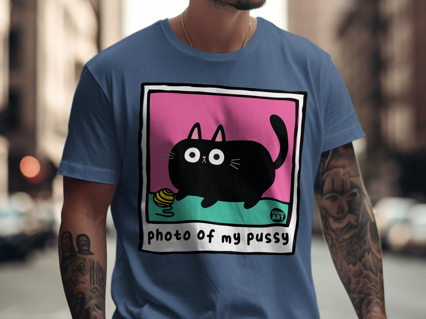 Black cat cartoon playing with yarn ball on t-shirt.