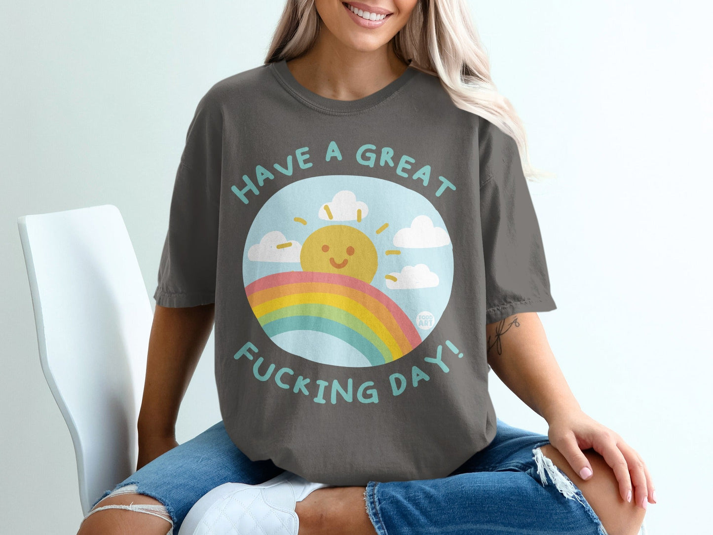 Dark grey t-shirt with "Have a great fucking day!" text and a sun and rainbow graphic.