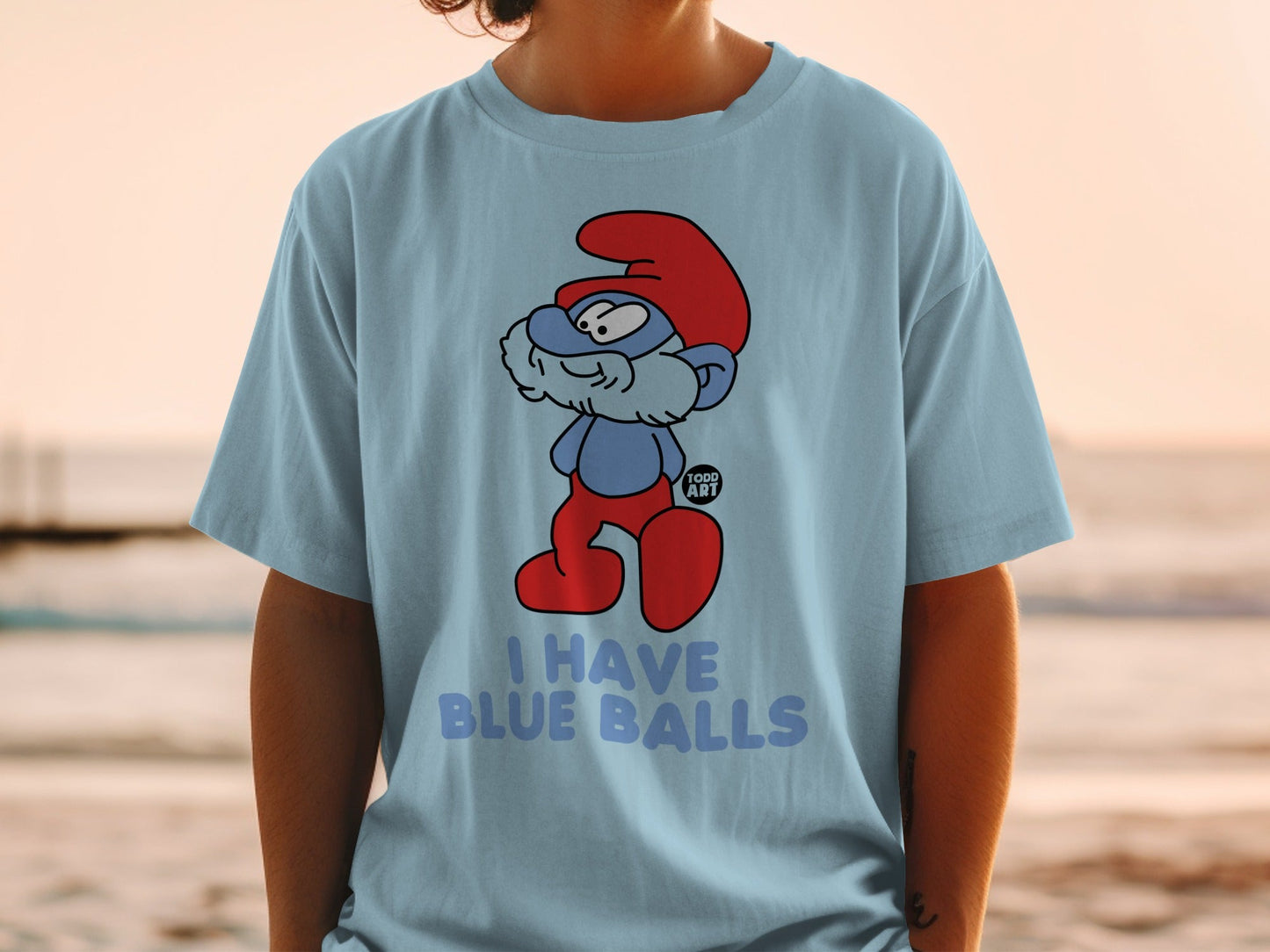 Light blue t-shirt with cartoon Smurf saying "I HAVE BLUE BALLS".