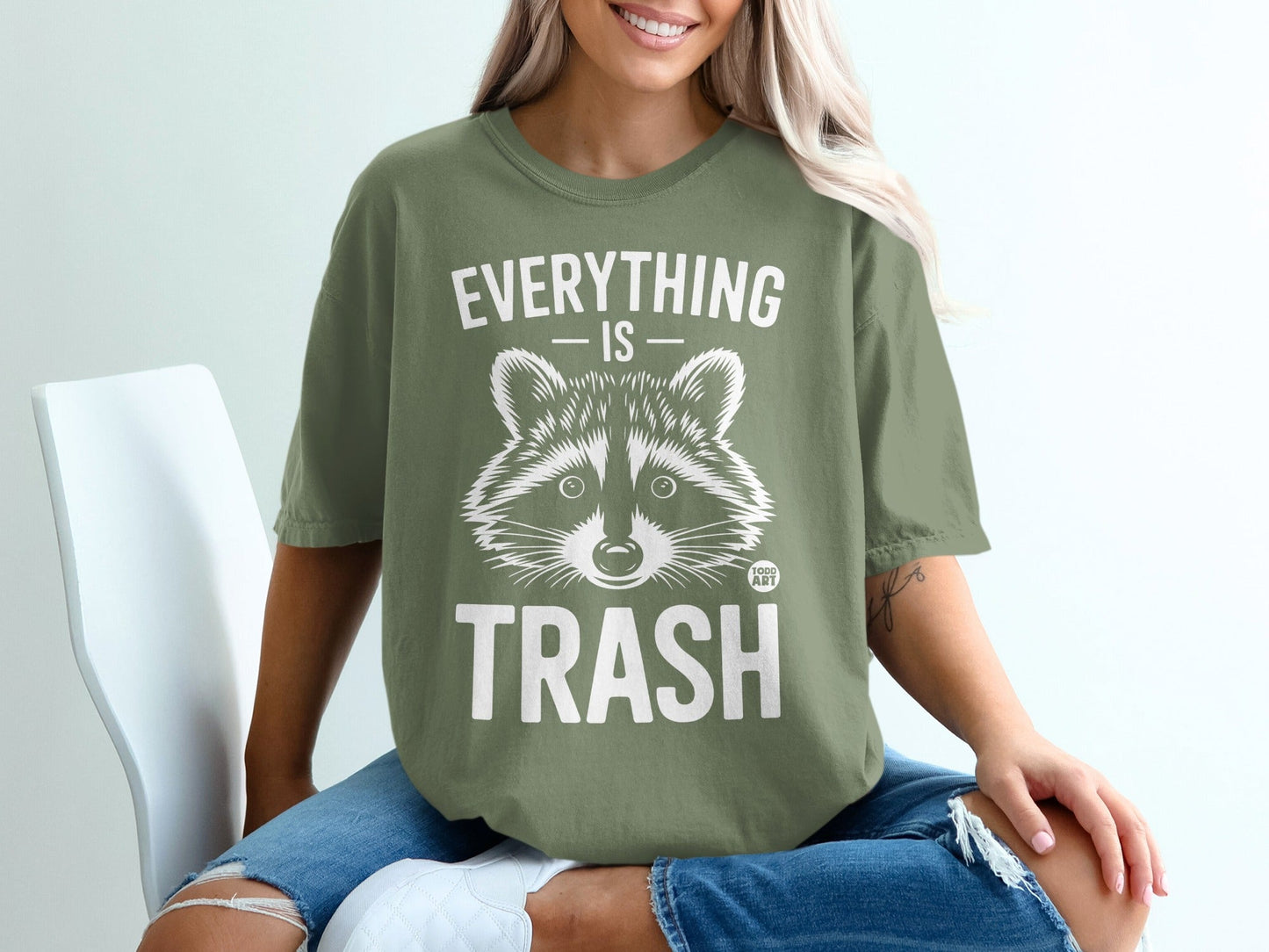 Green t-shirt with raccoon graphic and "EVERYTHING IS TRASH" text.