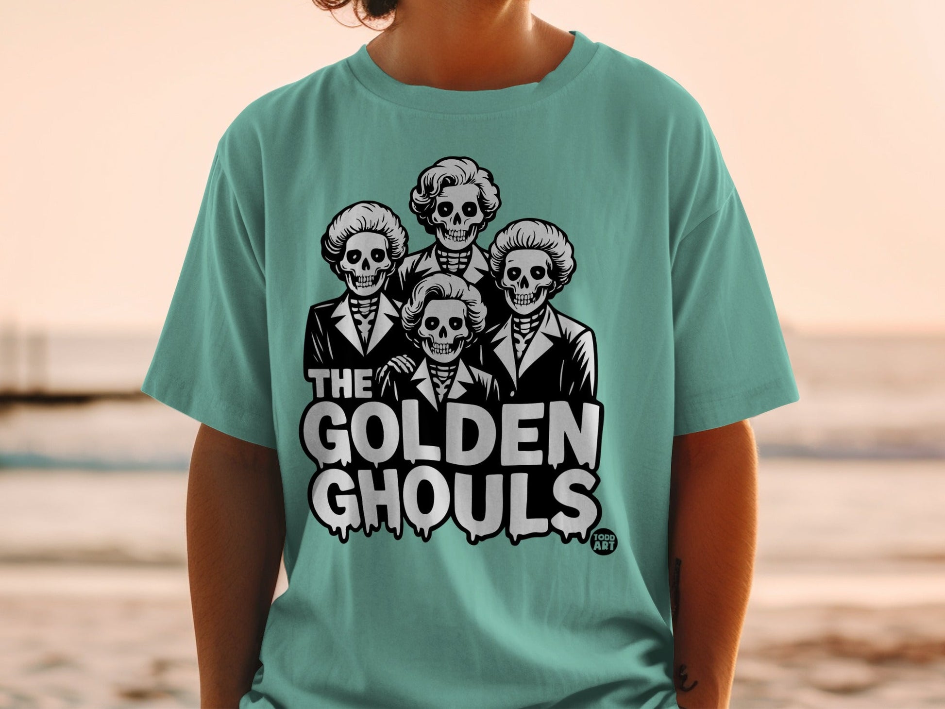 T-shirt featuring four skeletons in suits with "The Golden Ghouls" text.