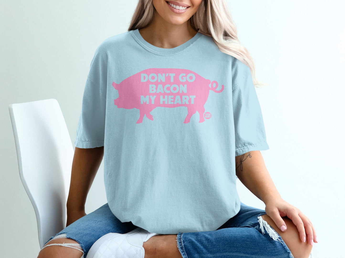 Light blue t-shirt with pink text "Don't Go Bacon My Heart" and pig graphic.