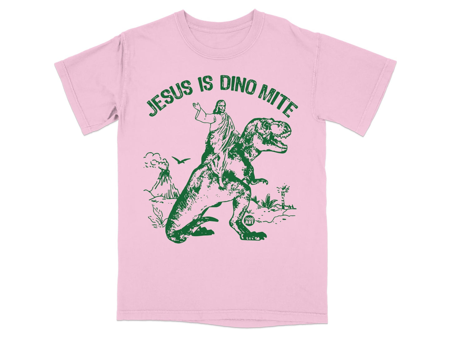 Pink t-shirt with green graphic of Jesus riding a T-Rex.