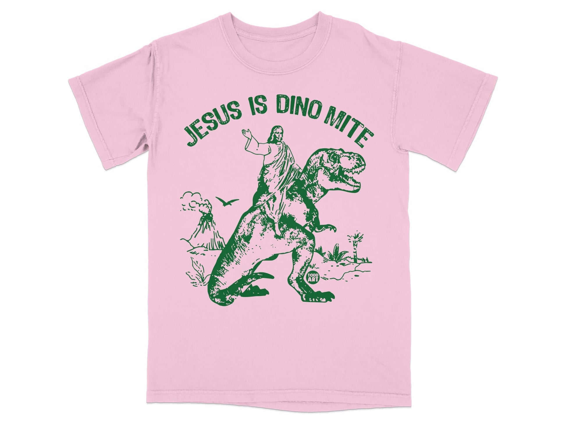 Pink t-shirt with green graphic of Jesus riding a T-Rex.