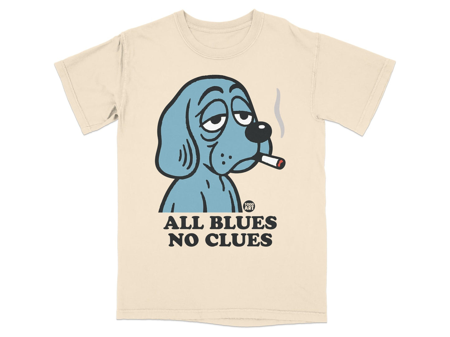 Blue dog with cigarette, "ALL BLUES NO CLUES" text on cream t-shirt.