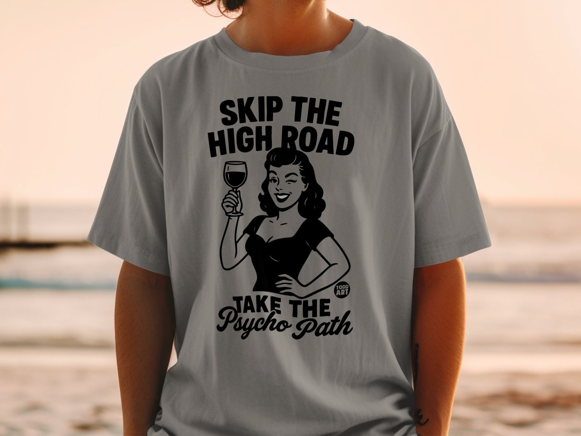 T-shirt with text "SKIP THE HIGH ROAD TAKE THE PSYCHO PATH" and cartoon woman.