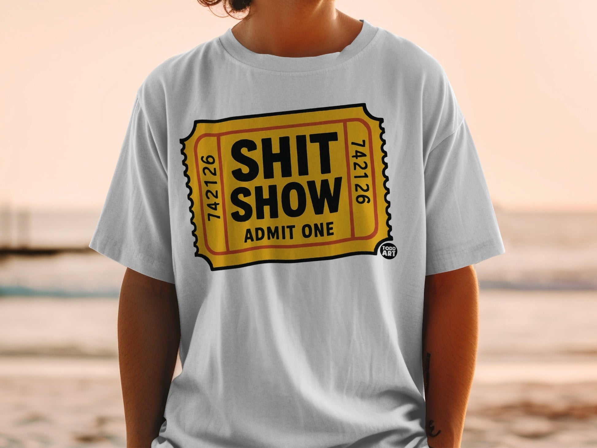 White t-shirt with "Shit Show Admit One" ticket design.
