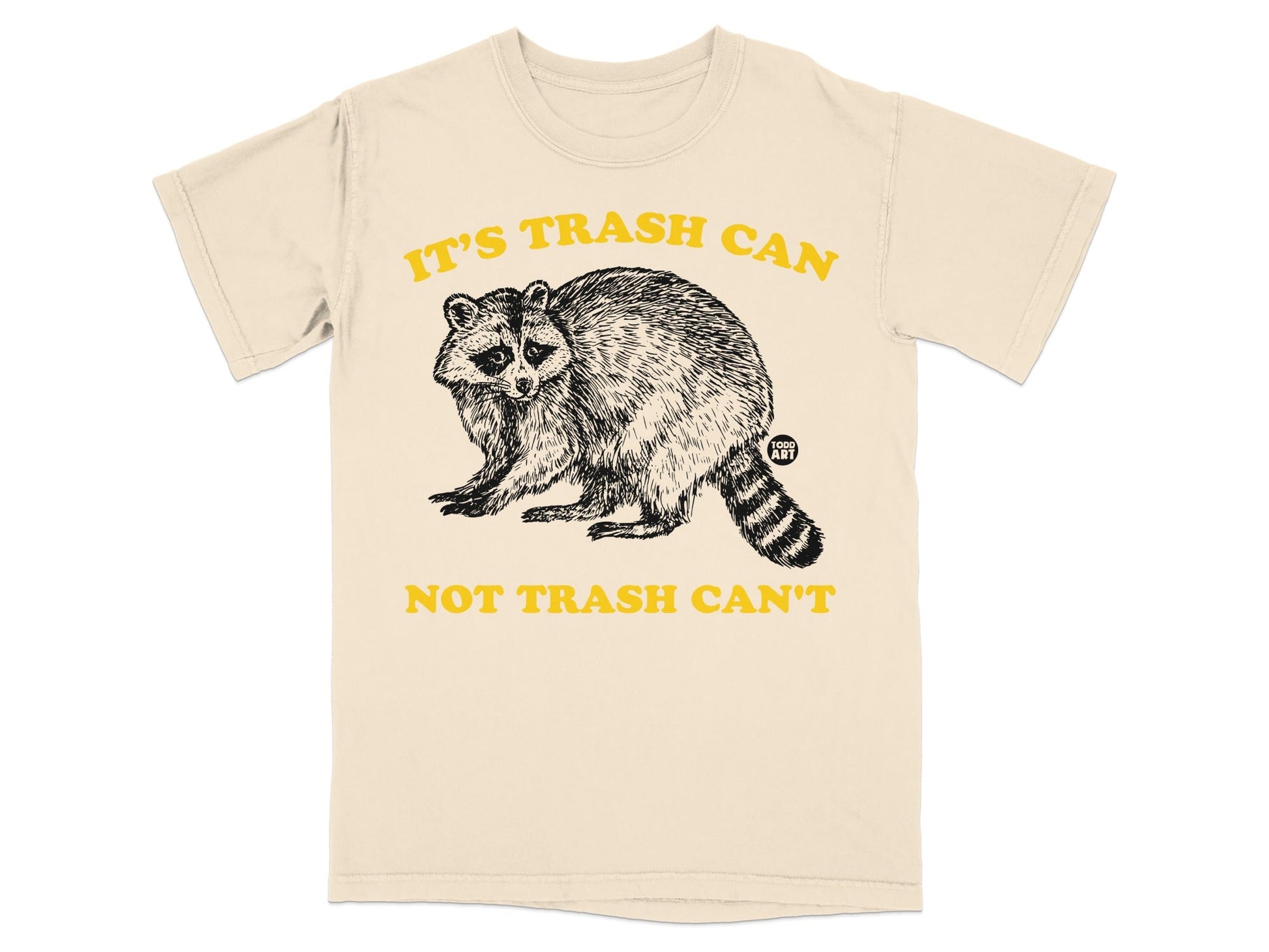 Cream t-shirt with raccoon graphic and "IT'S TRASH CAN NOT TRASH CAN'T" text.