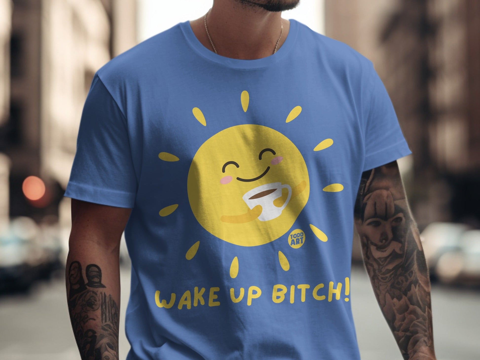 Blue t-shirt with cartoon sun holding coffee cup and "WAKE UP BITCH!" text.