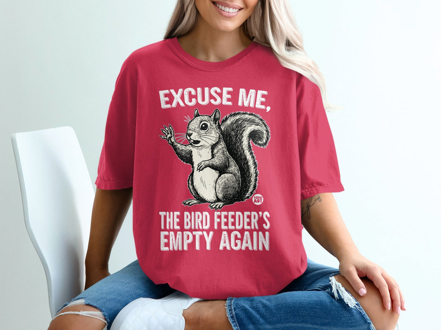 Squirrel graphic tee with "Excuse me, the bird feeder's empty again" text.