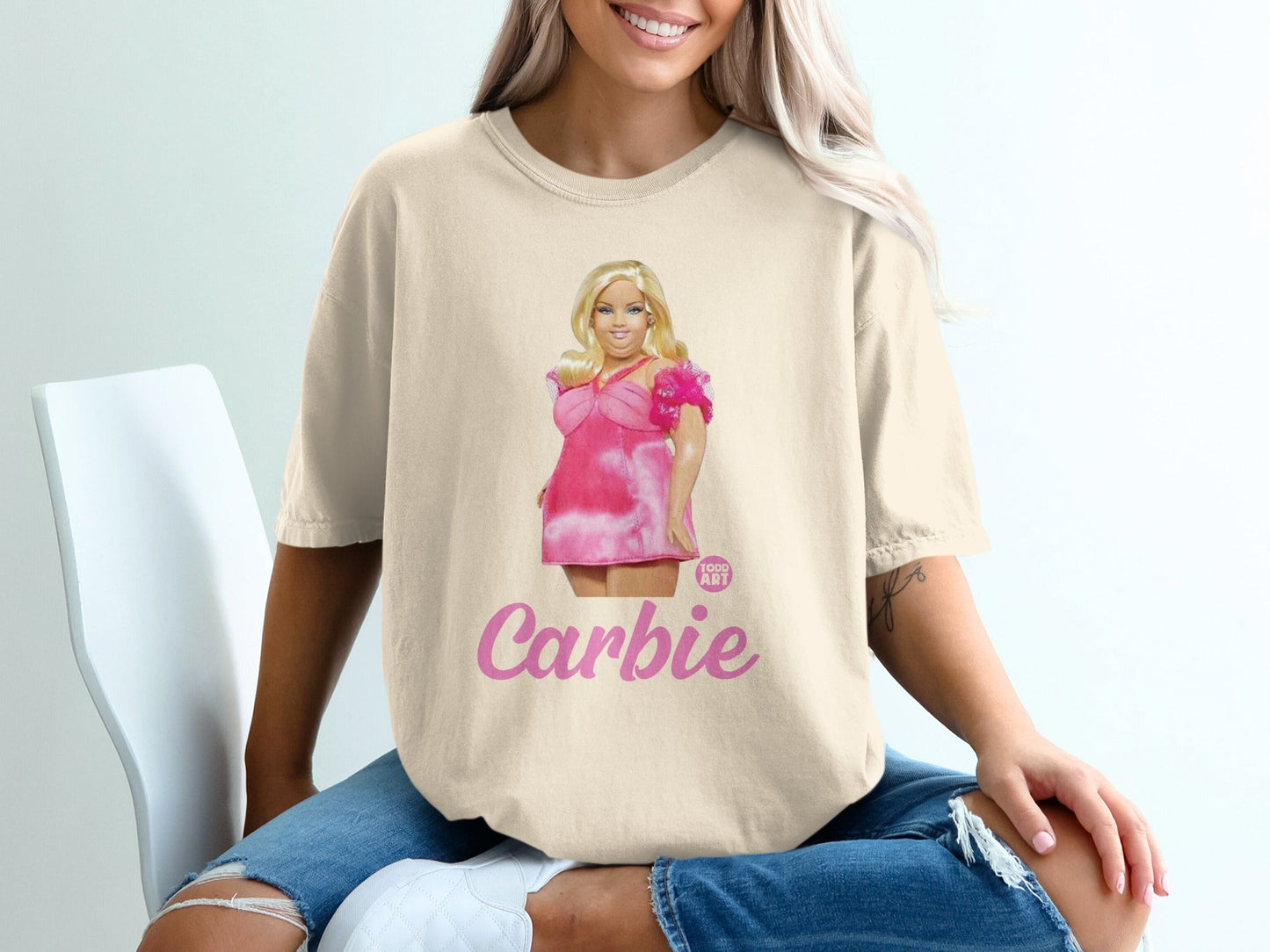 T-shirt featuring illustration of a woman named "Carbie" in a pink dress.