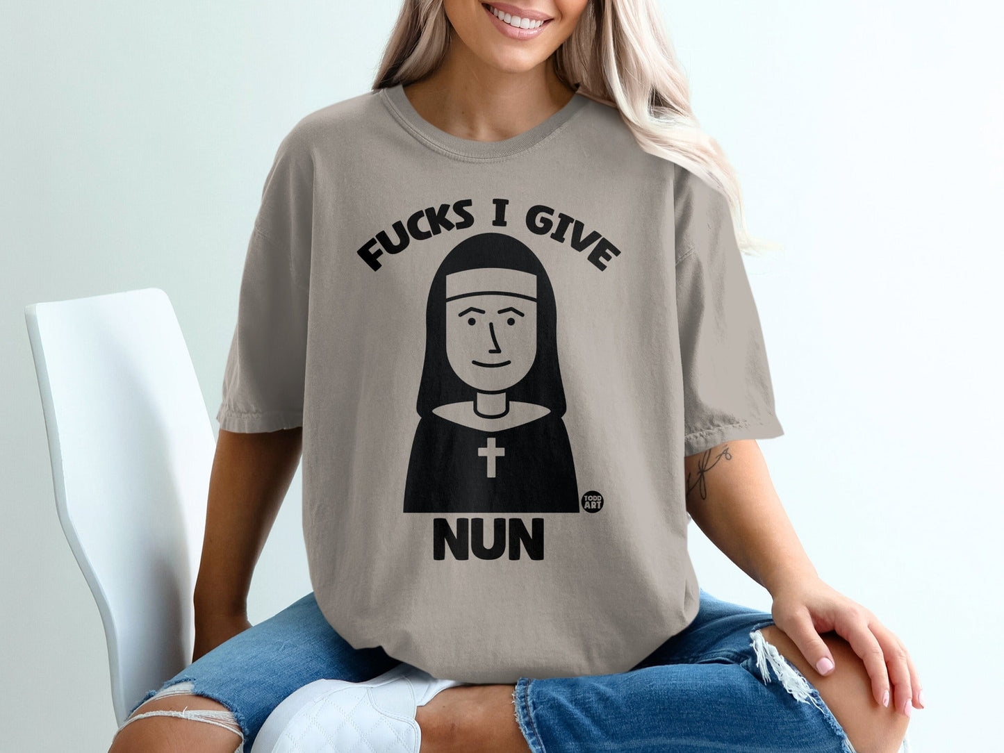 T-shirt with graphic of nun and text "FUCKS I GIVE NUN".