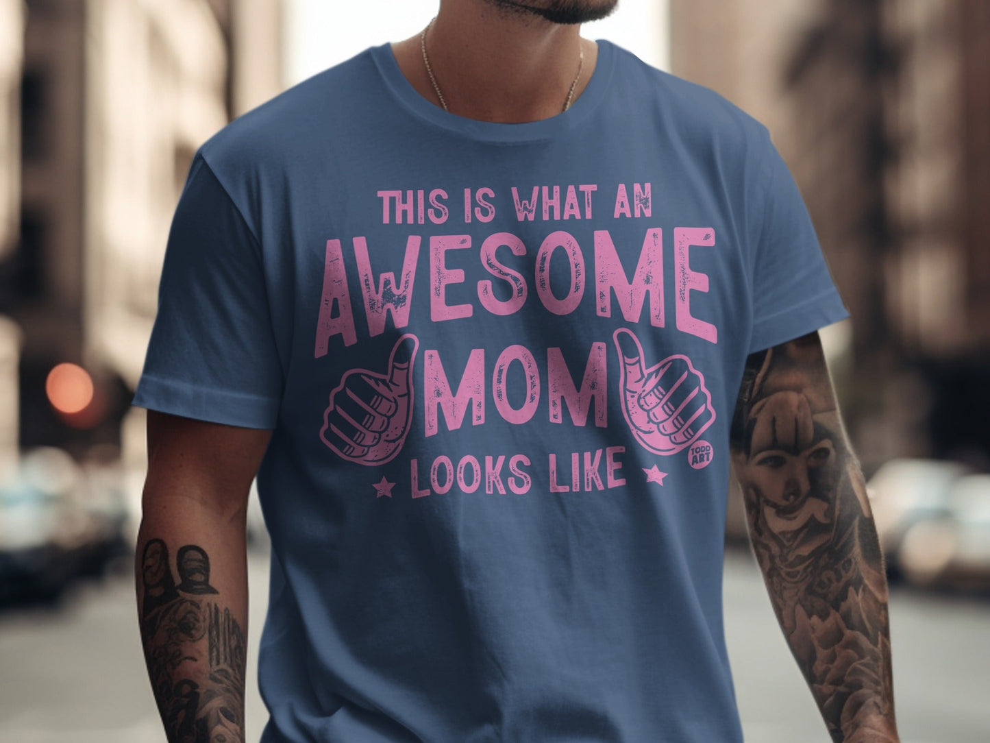 Blue t-shirt with pink text "This is what an awesome mom looks like" and thumbs up.