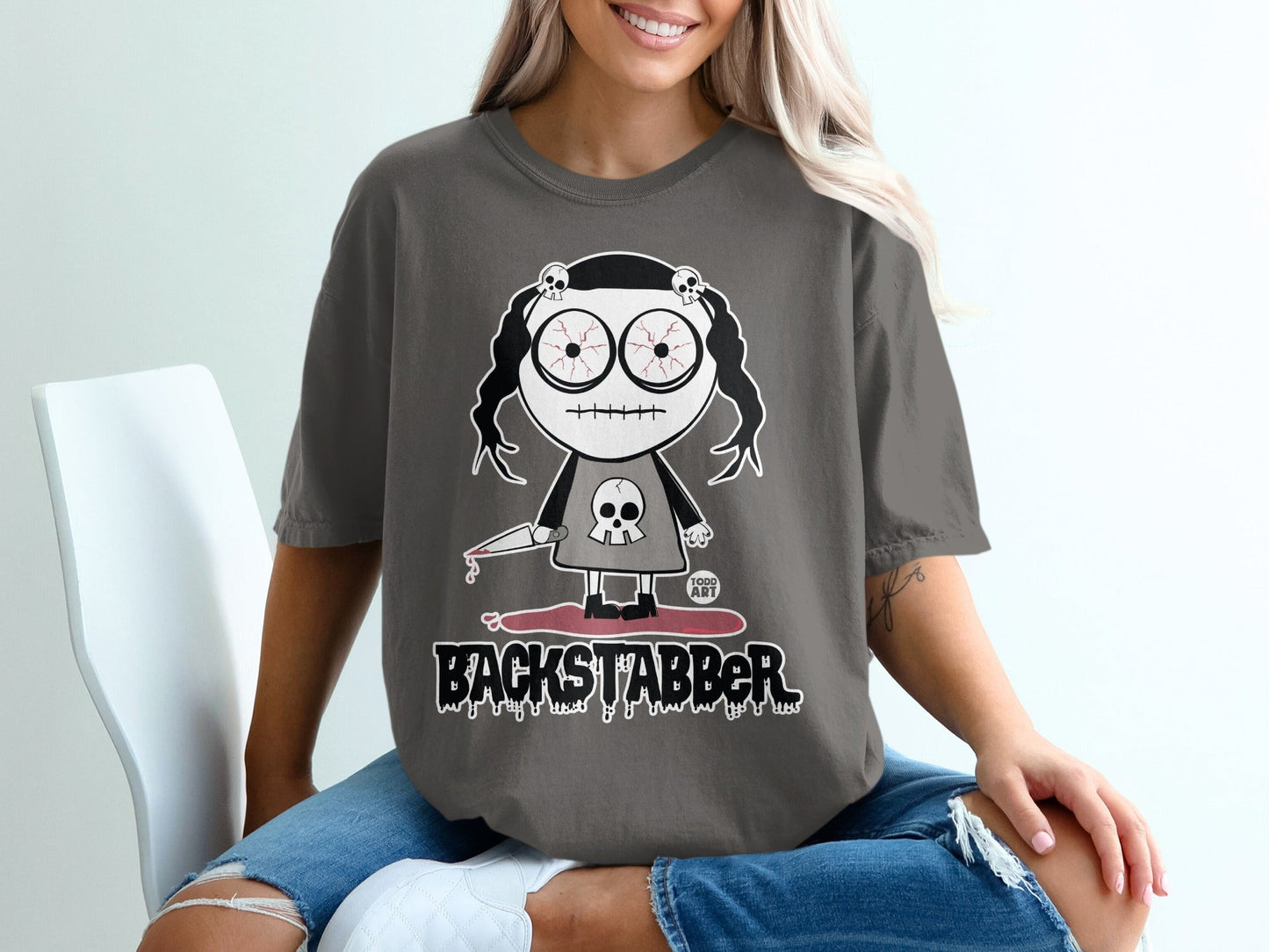 Backstabber Graphic Tee with Creepy Doll Design