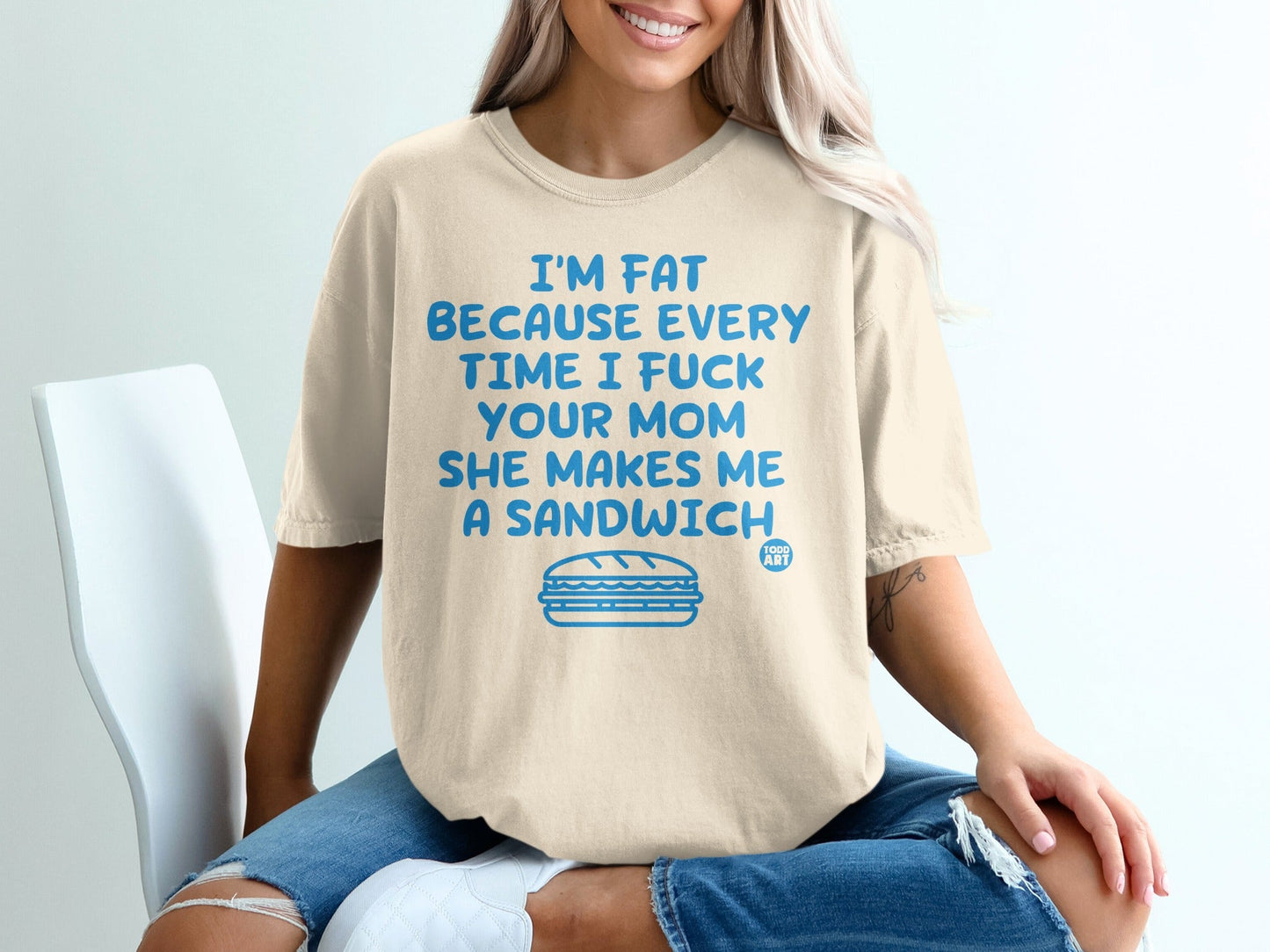Cream t-shirt with blue text and a sandwich graphic.