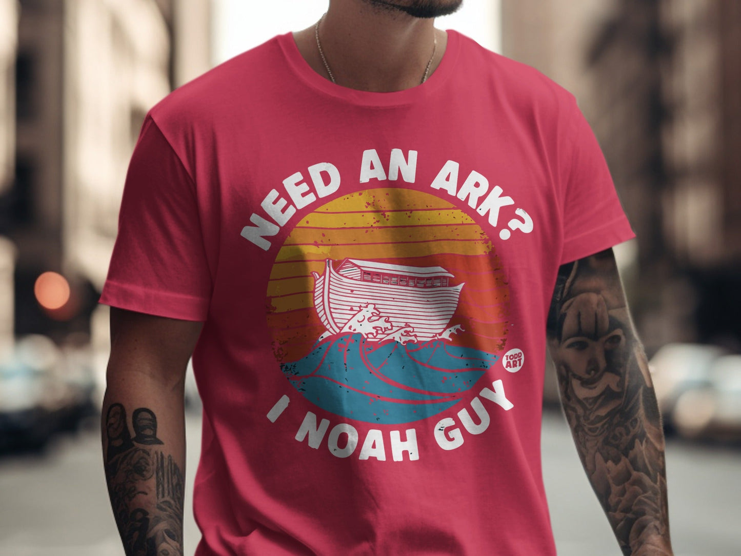 Red t-shirt with "Need an ark? I Noah guy" and an ark on waves graphic.