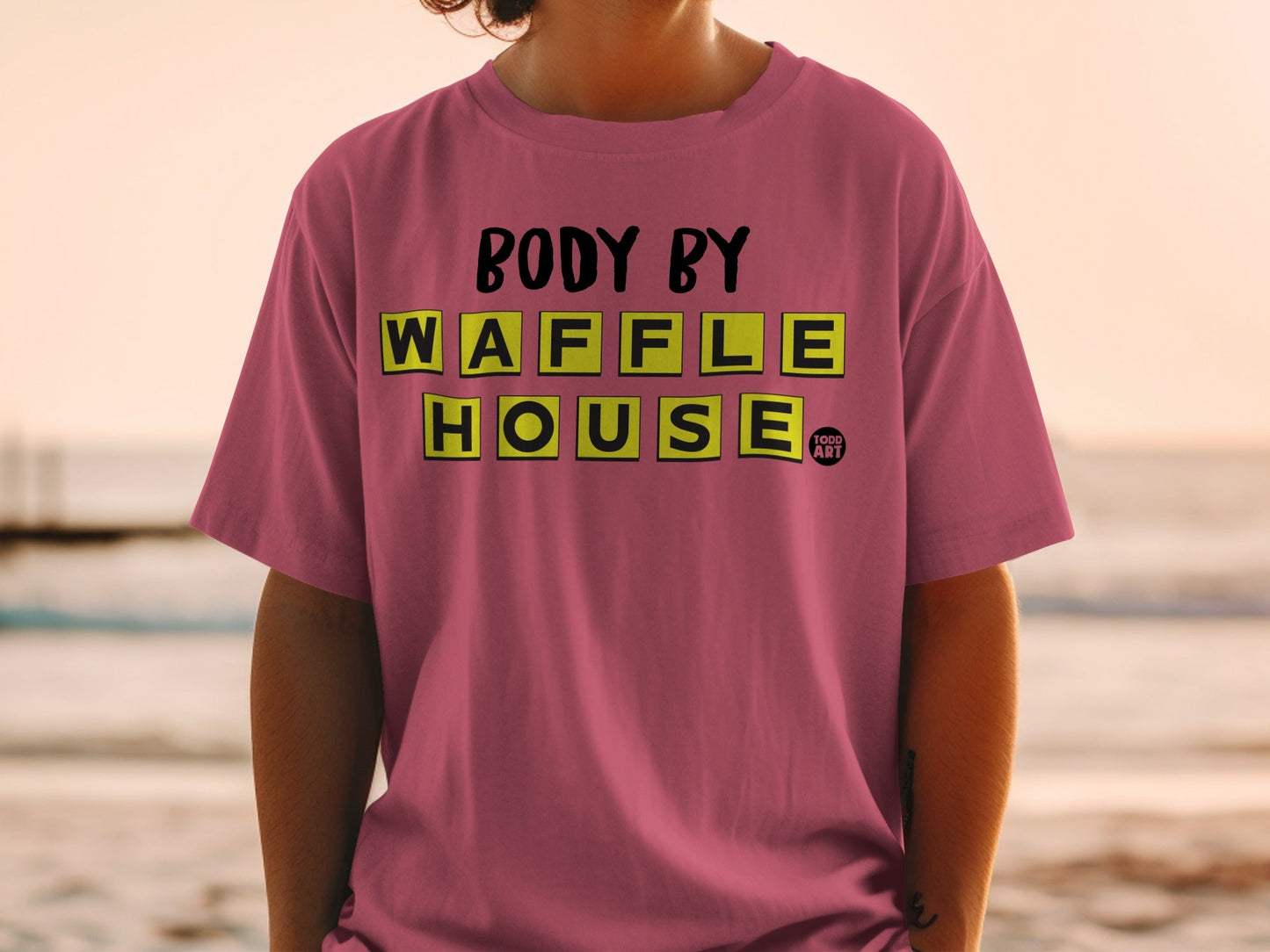 Pink t-shirt with "BODY BY WAFFLE HOUSE" text in yellow blocks.