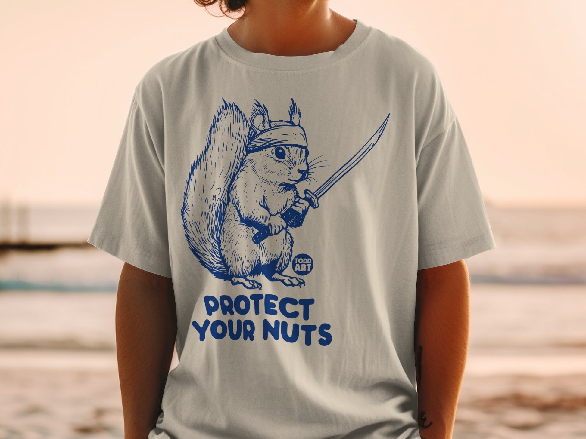 Squirrel with a sword and headband, text "TODD ART PROTECT YOUR NUTS".