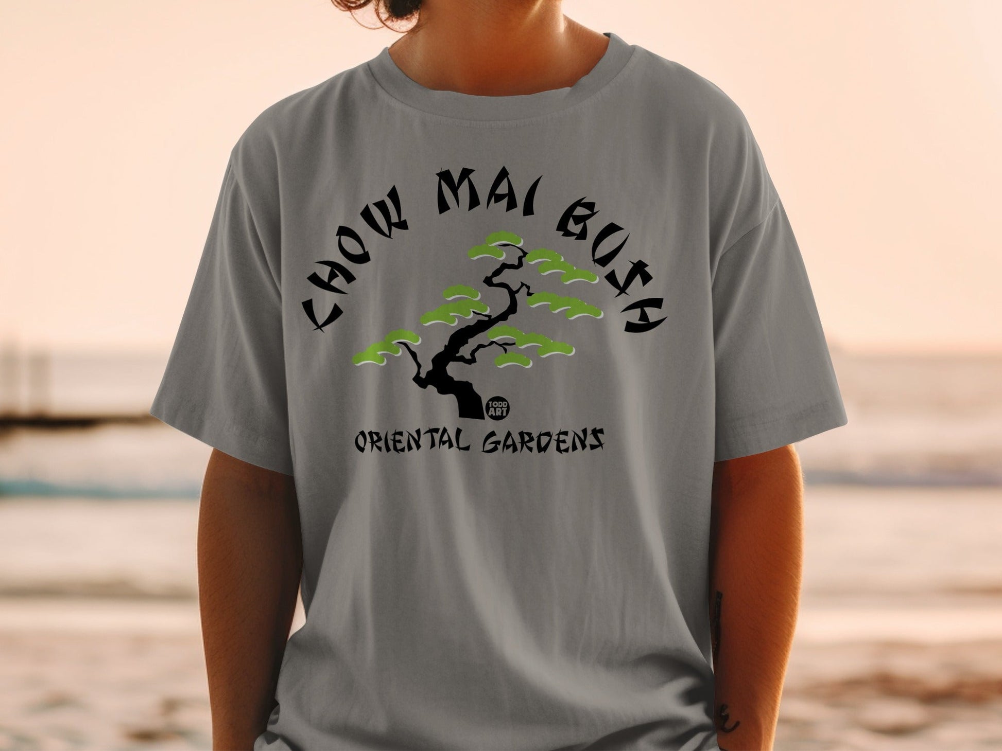 Grey t-shirt with "Chow Mai Gusa Oriental Gardens" text and stylized tree.