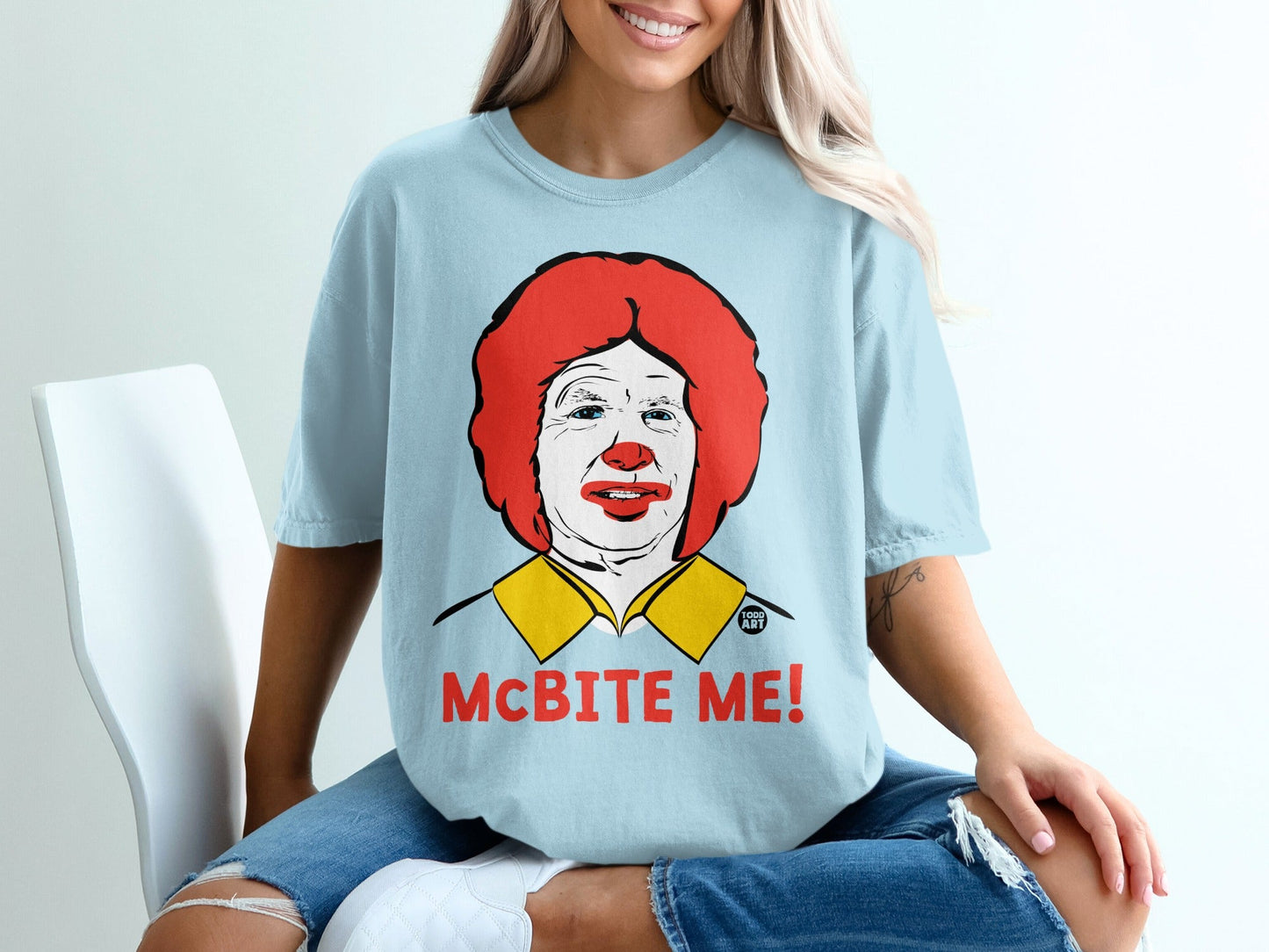 Light blue t-shirt with Ronald McDonald graphic and "McBite Me!" text.