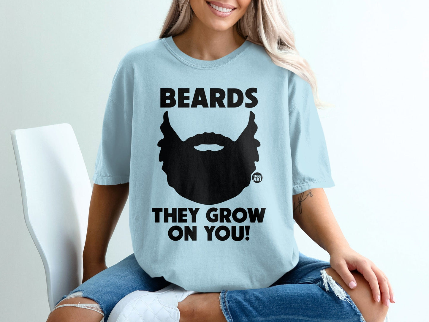 Light blue t-shirt with black beard graphic and text "BEARDS THEY GROW ON YOU!".