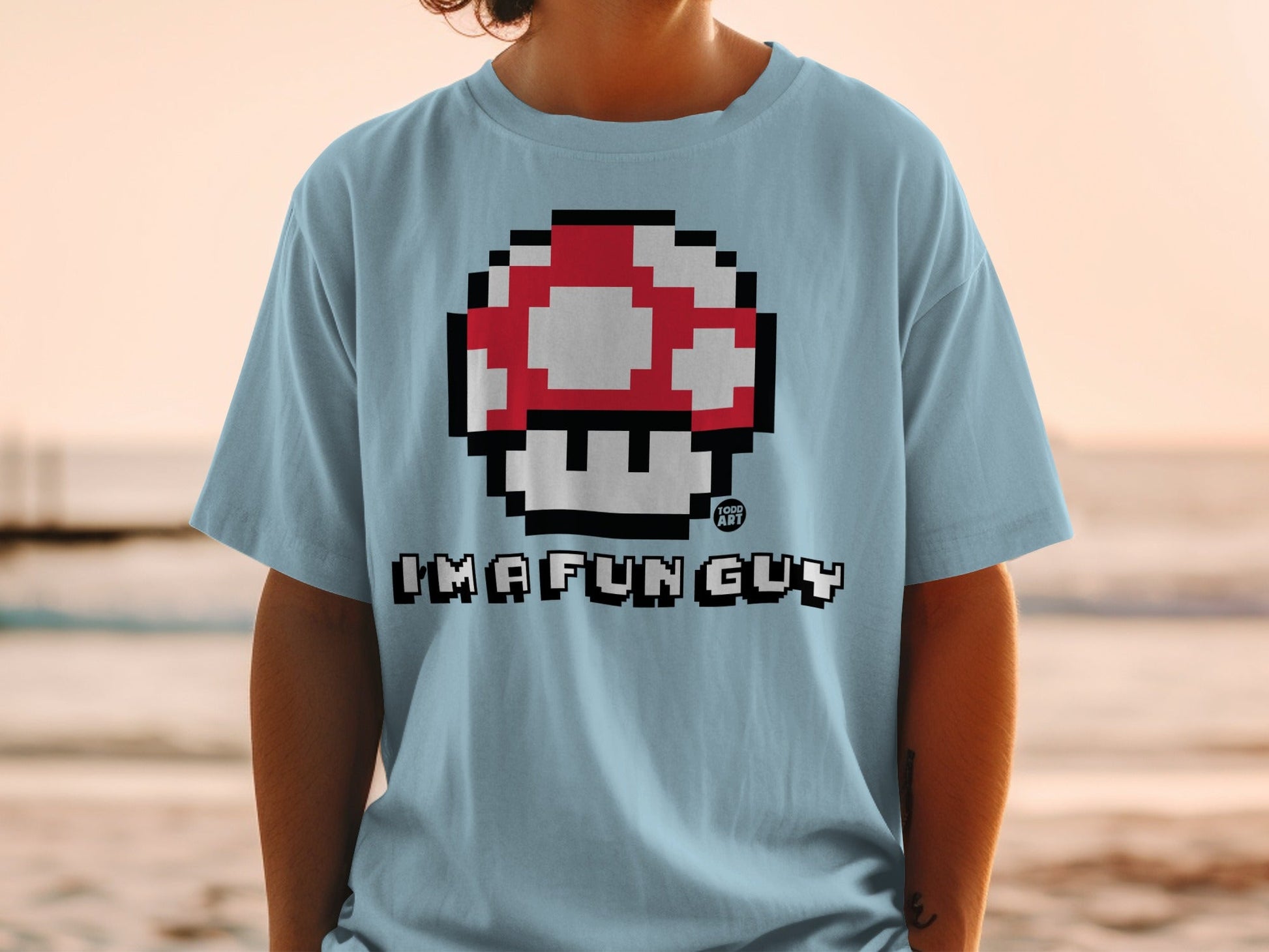 Light blue t-shirt with 8-bit mushroom and "IMA FUN GUY" text.