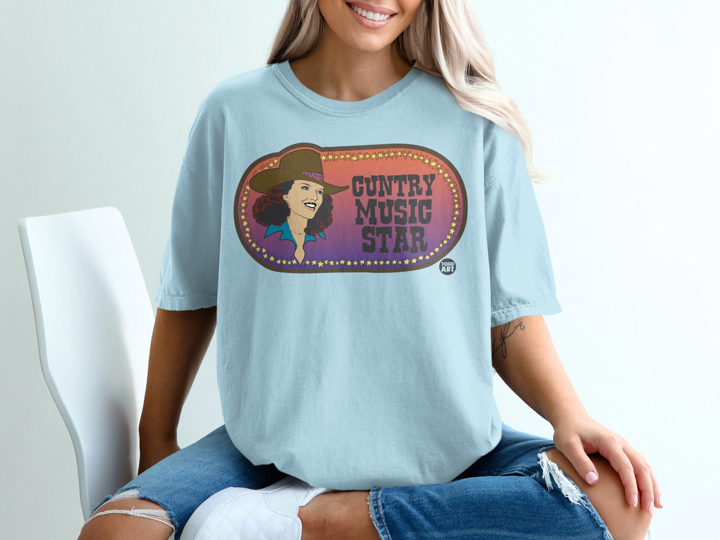 Light blue t-shirt with "Guntry Music Star" text and starburst graphic.