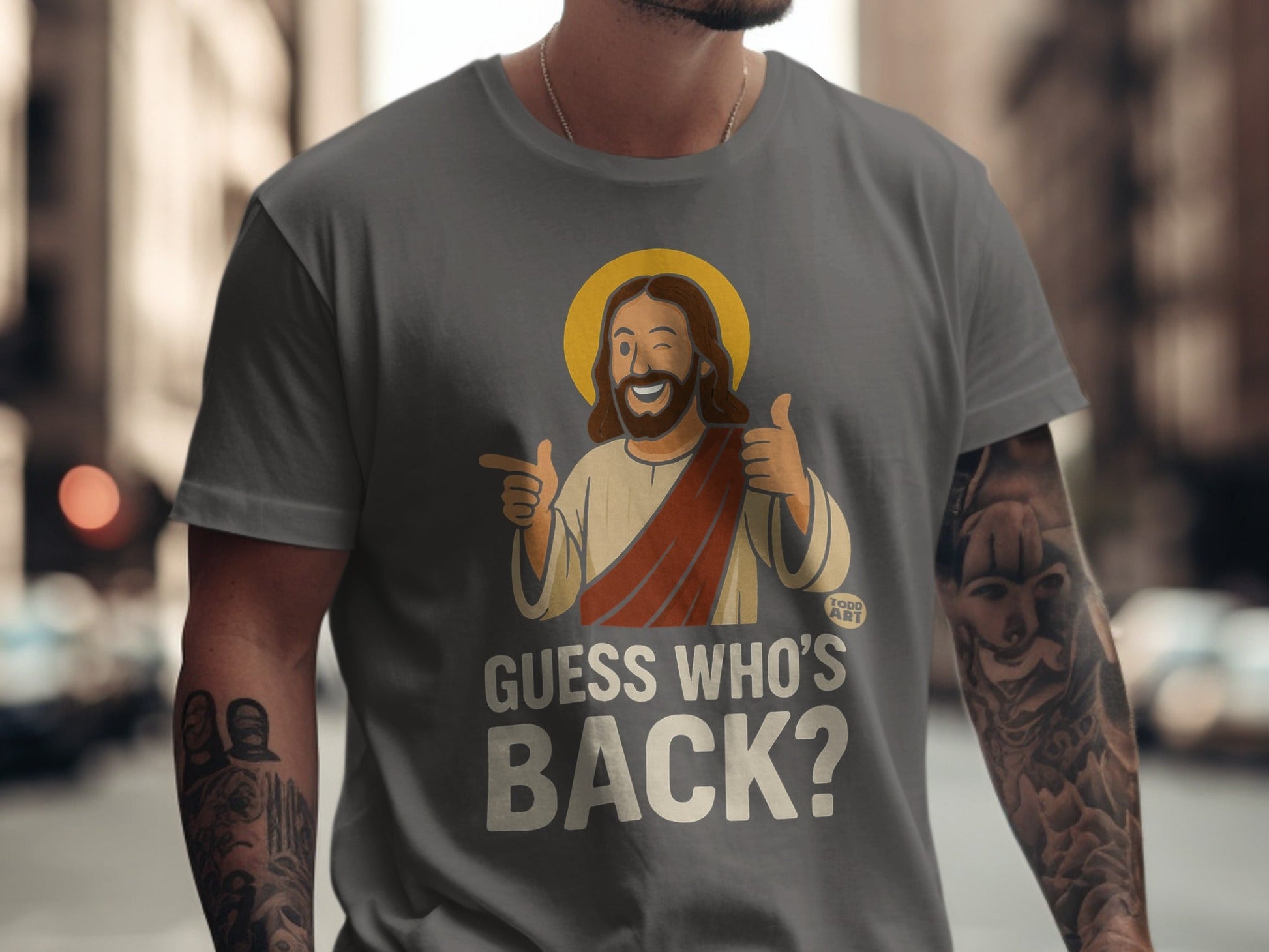 T-shirt with cartoon Jesus giving thumbs up, text "GUESS WHO'S BACK?"