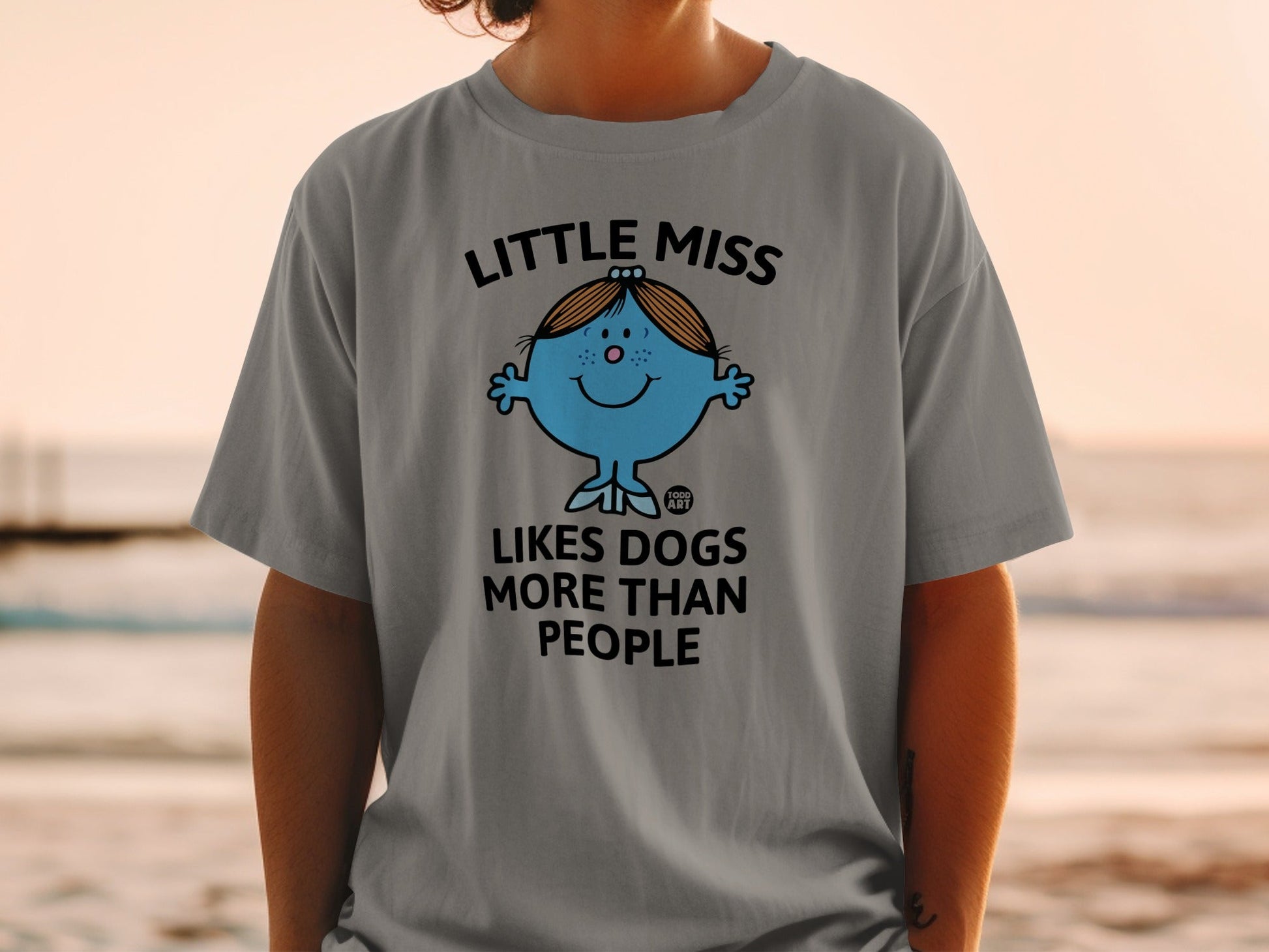 Grey t-shirt with "Little Miss Likes Dogs More Than People" text and cartoon.