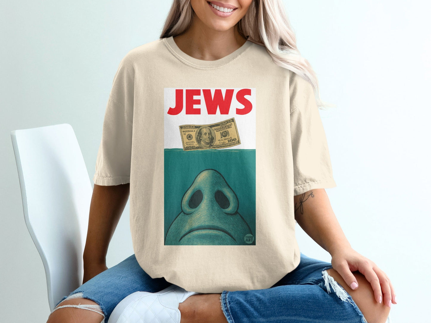 T-shirt with "JEWS" text above a close-up of a shark's snout and a submerged dollar bill.