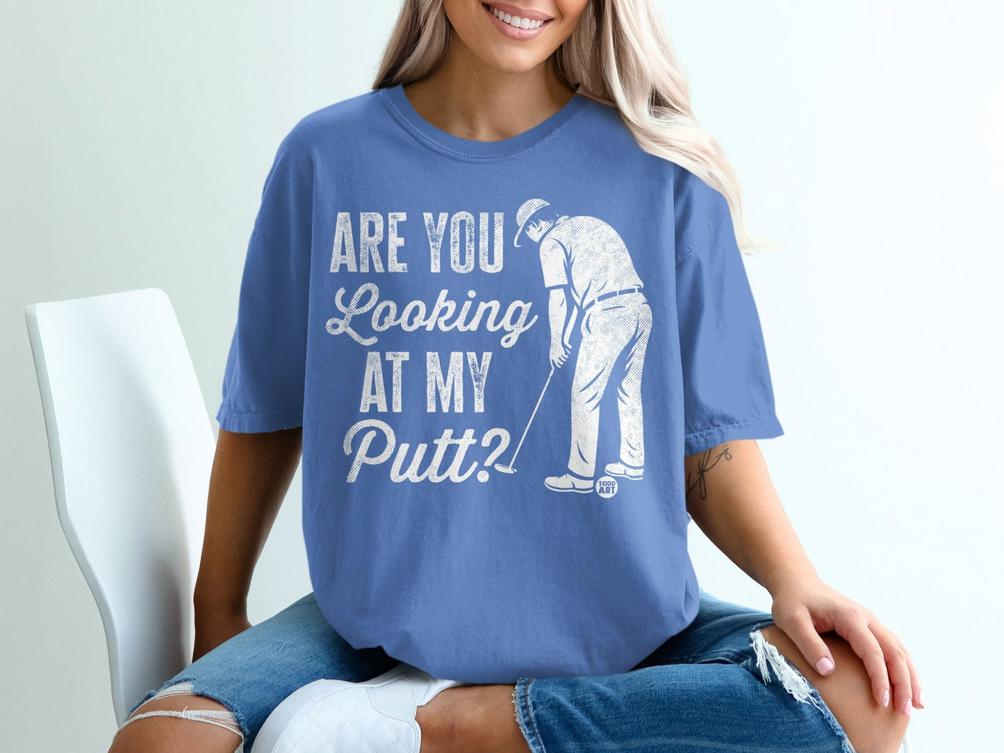 Blue t-shirt with "Are you looking at my putt?" graphic.