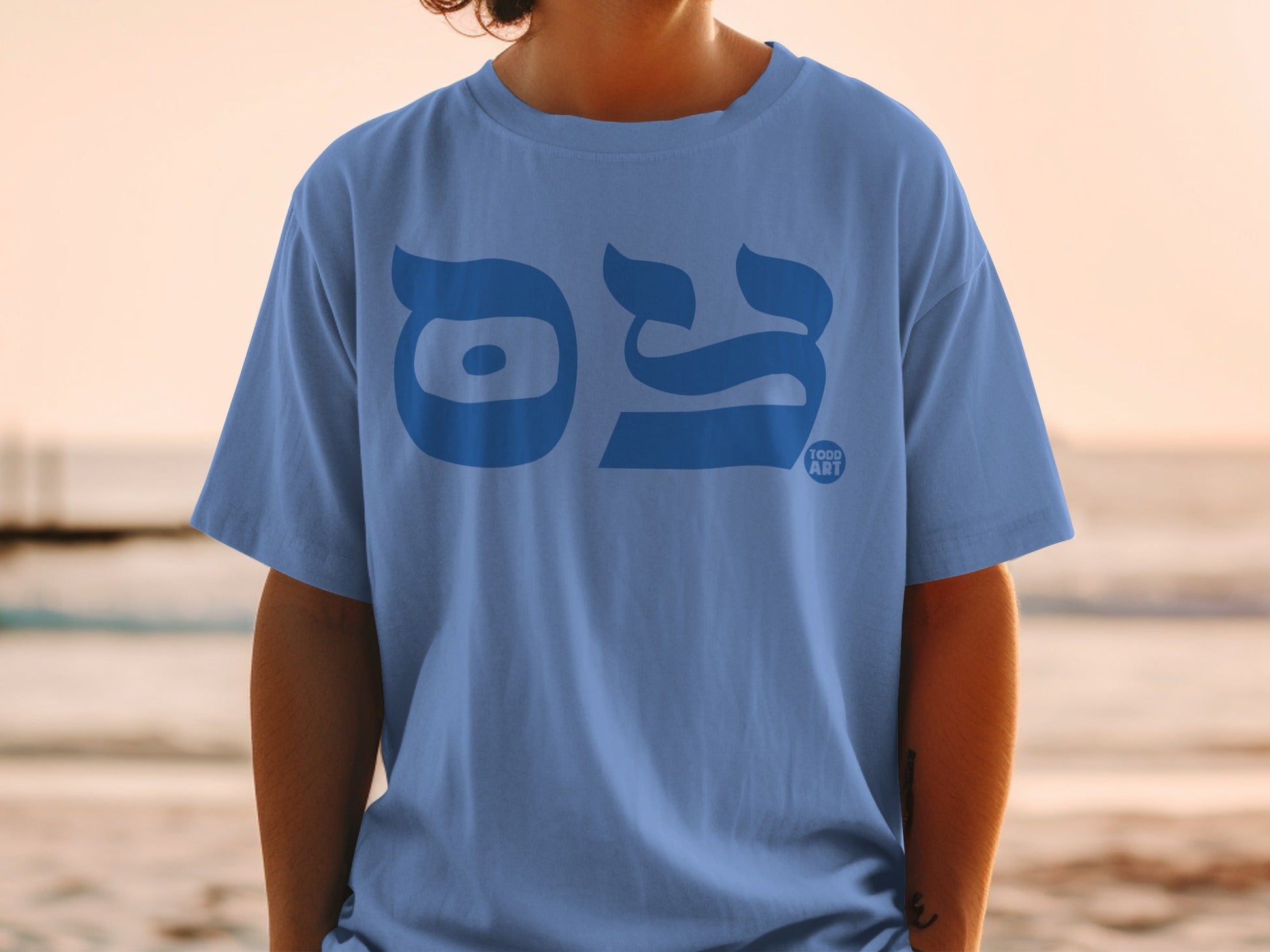 Blue t-shirt with Hebrew lettering and "TOOD ART" logo.