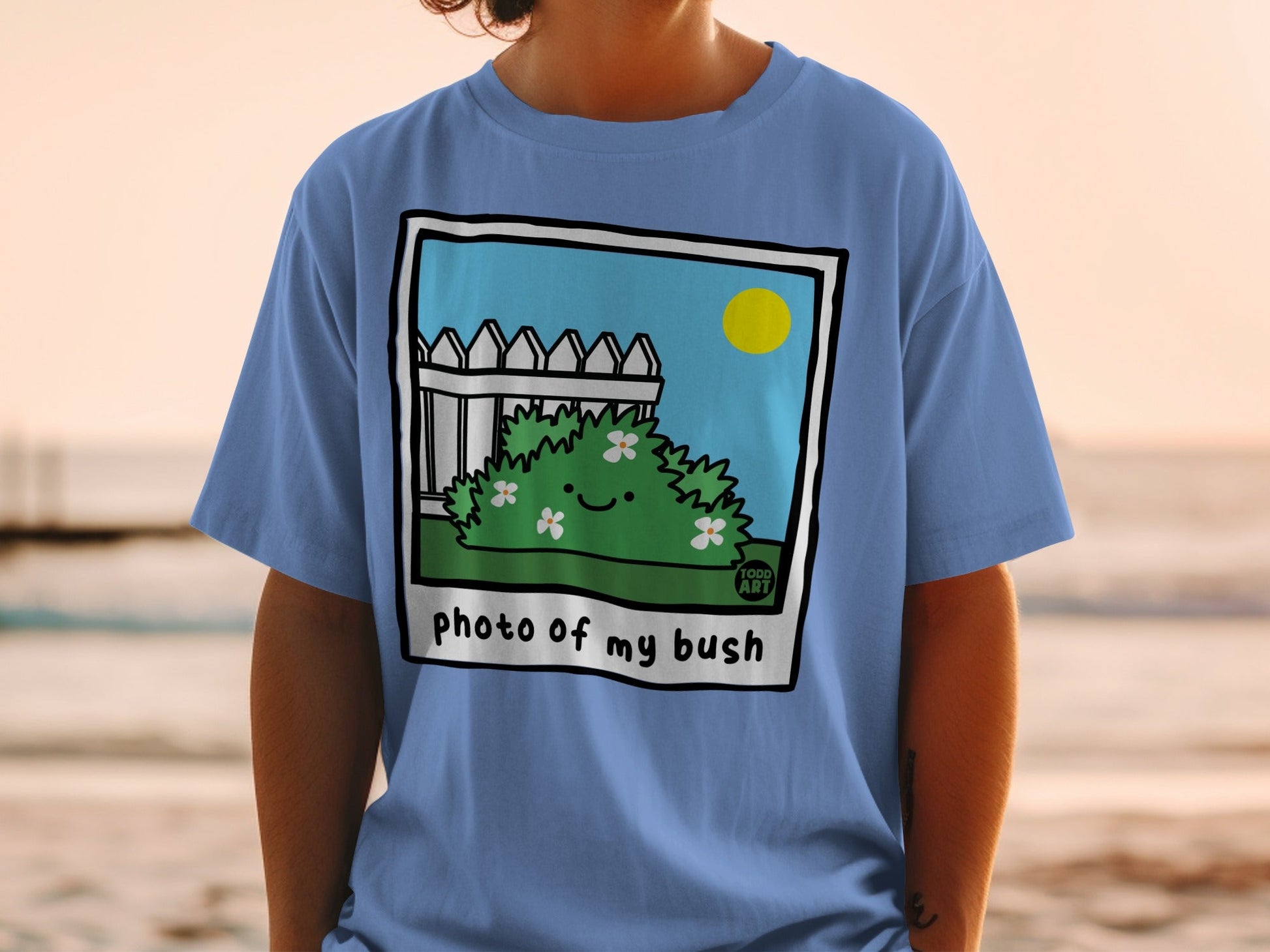 T-shirt with cartoon bush and "photo of my bush" text.