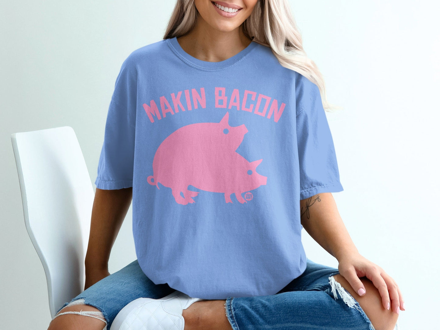 Blue t-shirt with "Makin' Bacon" and two pink pigs design.