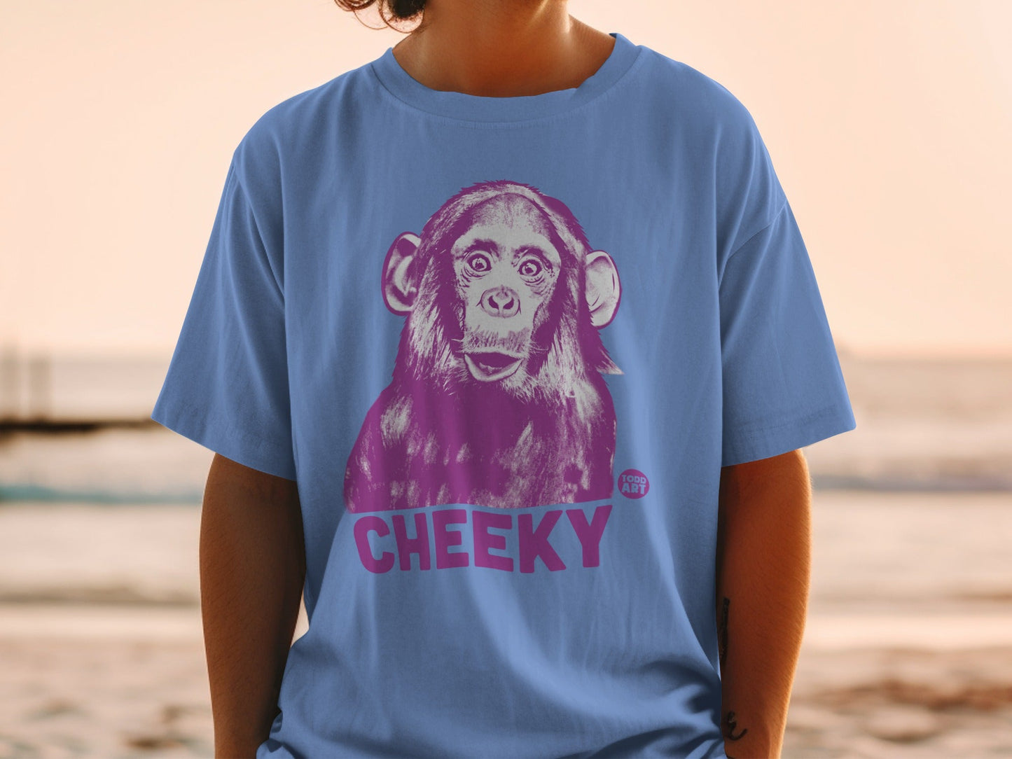 Purple chimpanzee graphic on a blue t-shirt with "CHEEKY" text.