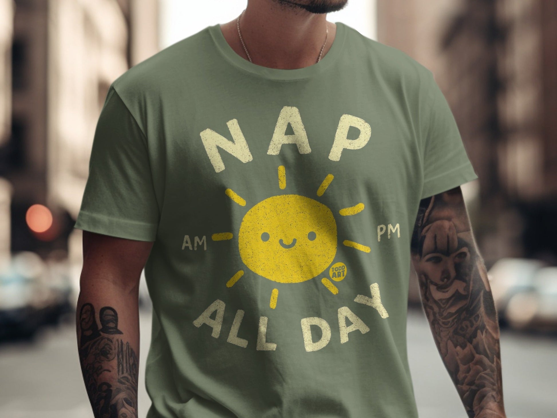 Green t-shirt with "NAP ALL DAY" text and a smiling sun graphic.